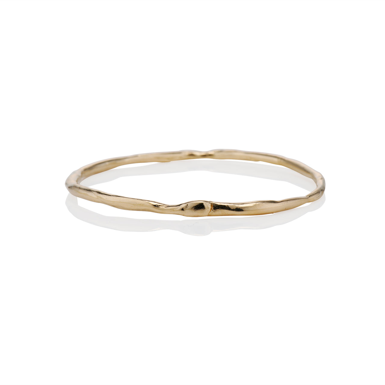 A gold bangle bracelet with a solid pattern and a shiny finish.